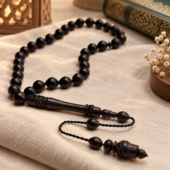 Handmade ebony 33 bead Tasbih arranged beside a Qur'an and lantern