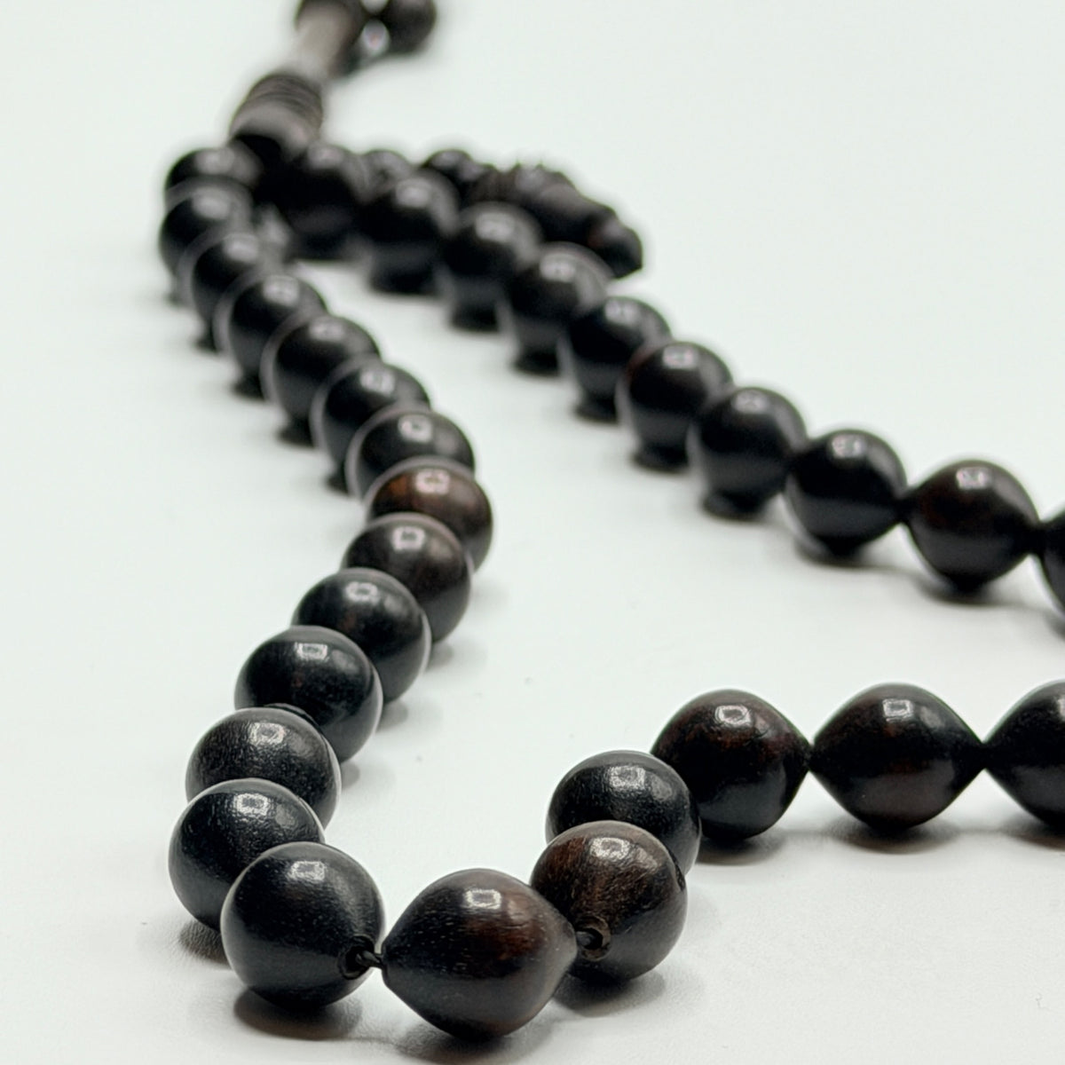Close view of the natural grain in polished ebony Tasbih beads