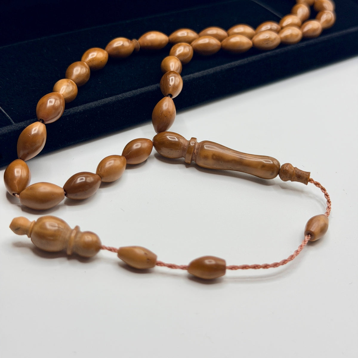 Close view of the warm grain and polished finish of Kuka wood prayer beads