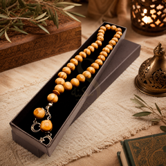 Olivewood Zikr 33 bead Tasbih in its black gift box beside a Qur'an and lantern