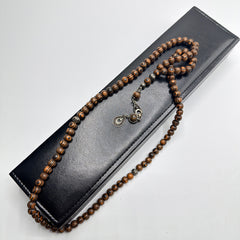Kafur camphor wood 99 bead Tasbih displayed over the closed luxury leather box