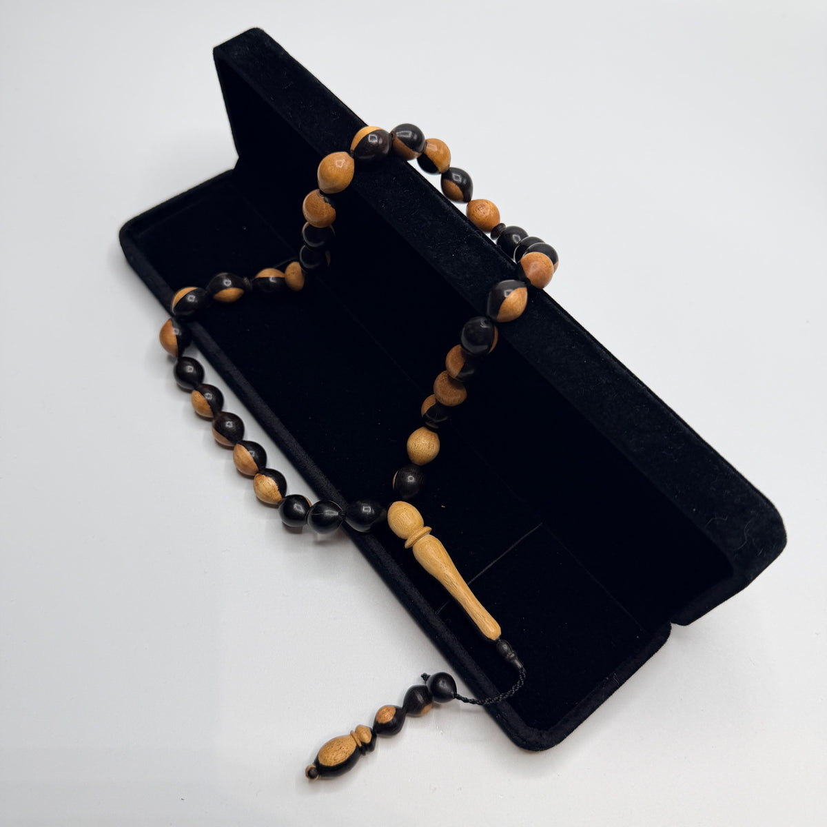 Two-tone ebony wood 33 bead tasbih displayed with its box