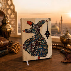 Sufi A5 notebook styled beside books, lanterns and tasbih at sunset