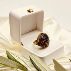Angled view of the large black aqeeq ring with ornate antique finish