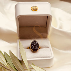 Small black aqeeq brass ring with Allah calligraphy, presented in a Sakinah ring box