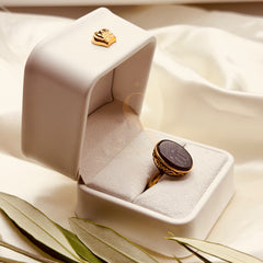 Side view of the small black aqeeq ring and antique gold tone setting