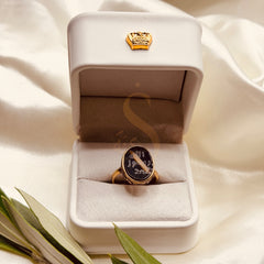 Small black aqeeq brass ring with Prophetic Seal inspired calligraphy, presented in a Sakinah ring box