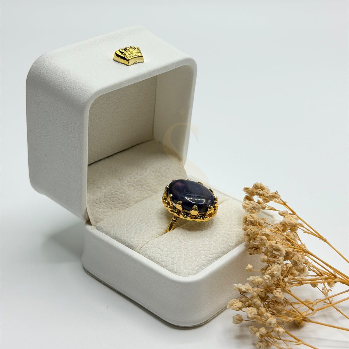 Side view of the polished purple Amethyst stone and ornate gold plated setting