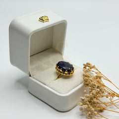 Side view of the polished purple Amethyst stone and ornate gold plated setting