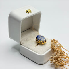 Side view of the blue and white Sodalite stone and ornate gold plated setting