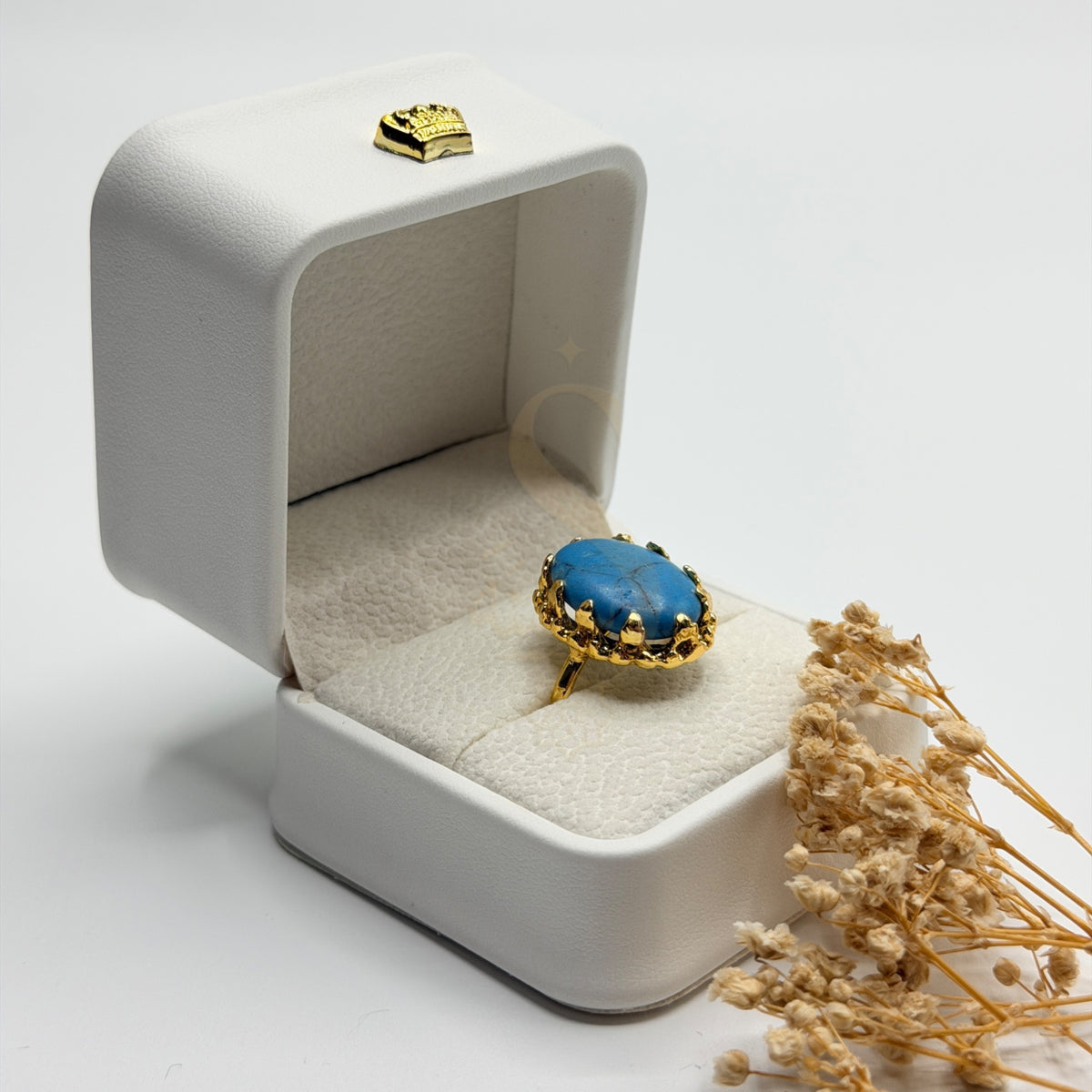 Side view of the blue Turquoise Feroza stone and ornate gold plated handmade setting