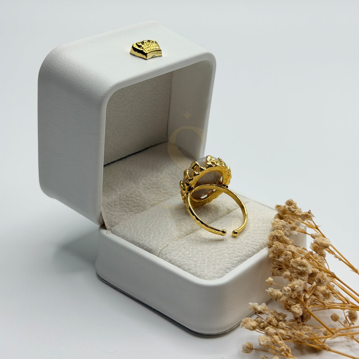 Rear view of the white Sulemani Aqeeq ring showing its adjustable gold plated band