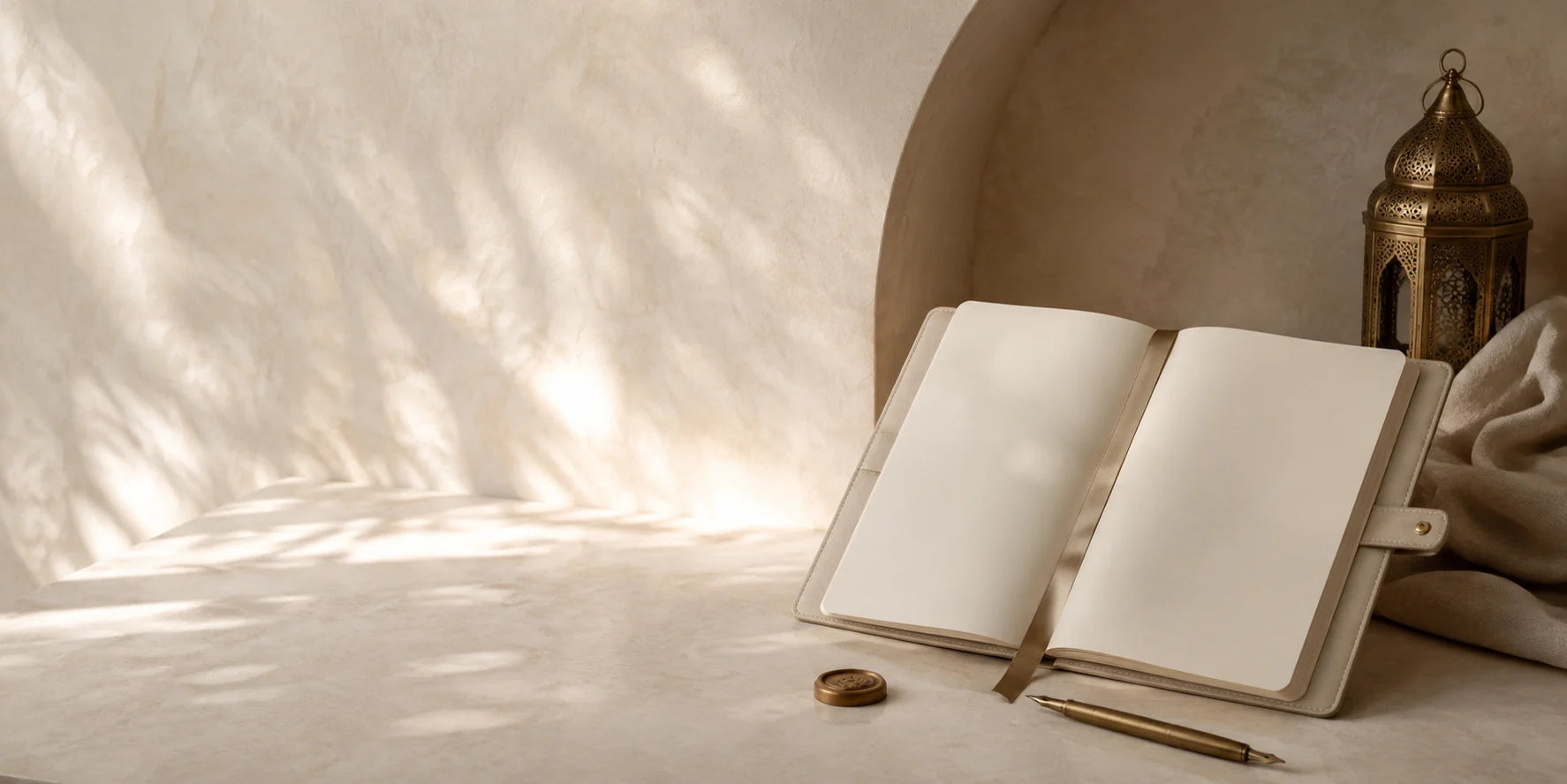 A blank cream folio, antique brass pen and seal within a softly lit arch
